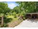 View of the exterior side yard with a wood shelter and natural growth at 208 Devonport Dr # 25, Weddington, NC 28104