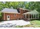 Exterior view of a brick home with a screened-in porch and a spacious patio at 208 Devonport Dr # 25, Weddington, NC 28104