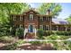 Charming brick home featuring a bright blue front door and manicured landscaping at 208 Devonport Dr # 25, Weddington, NC 28104