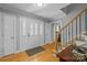 Warm foyer featuring a leaded glass front door, hardwood floors and staircase at 208 Devonport Dr # 25, Weddington, NC 28104