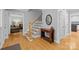 Inviting foyer with hardwood floors, staircase, and a view into the adjacent living area at 208 Devonport Dr # 25, Weddington, NC 28104