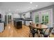 Open kitchen with white cabinets, a center island, stainless steel appliances and a sun-drenched breakfast area at 208 Devonport Dr # 25, Weddington, NC 28104