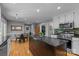 Bright kitchen boasts a large island, stainless steel appliances, and an adjacent breakfast nook, perfect for modern living at 208 Devonport Dr # 25, Weddington, NC 28104