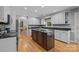 Well-lit kitchen with large island, granite counters, ample cabinet space, and hardwood floors provide a functional design at 208 Devonport Dr # 25, Weddington, NC 28104