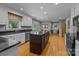 Spacious kitchen featuring a dark island, hardwood floors and stainless steel appliances at 208 Devonport Dr # 25, Weddington, NC 28104