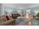 Cozy living room featuring a large rug, comfortable seating, and bright, neutral walls at 208 Devonport Dr # 25, Weddington, NC 28104