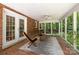 Enclosed porch with brick flooring, ceiling fan, and tranquil views of nature at 208 Devonport Dr # 25, Weddington, NC 28104