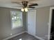 Cozy bedroom featuring neutral tones, a ceiling fan, and bright natural light from a window at 209 Brookview Rd, Statesville, NC 28625