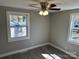 Bright bedroom with sleek flooring, ceiling fan, and natural lighting from two bright windows at 209 Brookview Rd, Statesville, NC 28625