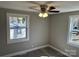 Neutral bedroom with sleek flooring, ceiling fan, and natural lighting from two bright windows at 209 Brookview Rd, Statesville, NC 28625