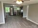 Kitchen features new gray cabinets, stainless steel refrigerator, and modern flooring at 209 Brookview Rd, Statesville, NC 28625