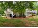 Charming backyard with lush greenery and landscaping, creating a serene outdoor space at 21136 Cold Spring Ln, Cornelius, NC 28031