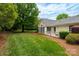 Expansive backyard with a mix of green lawn and manicured landscaping, offering privacy at 21136 Cold Spring Ln, Cornelius, NC 28031