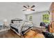 Cozy bedroom with wood floors, a chandelier, and bright natural light at 21136 Cold Spring Ln, Cornelius, NC 28031
