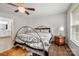 A bright bedroom with a decorative ceiling fan, wood floors, and ample light from the windows at 21136 Cold Spring Ln, Cornelius, NC 28031