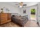 Comfortable bedroom with wood floors, a ceiling fan, and a walk-out porch at 21136 Cold Spring Ln, Cornelius, NC 28031
