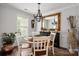 Elegant dining room with hardwood floors, chandelier, and a decorative mirror above a stylish buffet at 21136 Cold Spring Ln, Cornelius, NC 28031
