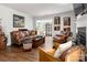Spacious living room with hardwood floors, fireplace, and stylish leather furniture at 21136 Cold Spring Ln, Cornelius, NC 28031