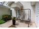 Cozy front porch with a charming swing, enhanced by potted flowers and a welcoming entrance at 21136 Cold Spring Ln, Cornelius, NC 28031