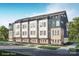 Modern townhome features a roof deck, a neutral color palette, and beautiful landscaping at 233 Cherokee Rose Ln # 31, Charlotte, NC 28217