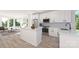 Bright, white kitchen with stainless steel appliances, center island, and an open concept at 233 Cherokee Rose Ln # 31, Charlotte, NC 28217