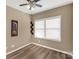Cozy bedroom with wood-look floors, a ceiling fan, and ample natural light from the large window at 246 Mallard Head Dr, Rock Hill, SC 29732