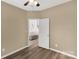 Neutral-toned bedroom with hardwood floors, featuring a closet, overhead light, and bright white door at 246 Mallard Head Dr, Rock Hill, SC 29732