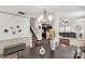 Bright dining area with modern chandelier, open to the kitchen, and featuring stairs to the second floor at 246 Mallard Head Dr, Rock Hill, SC 29732