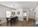 Charming dining area with stylish chandelier, wainscoting, and wood floors, perfect for entertaining guests at 246 Mallard Head Dr, Rock Hill, SC 29732