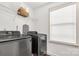 Efficient laundry room with modern washer and dryer, shelving, and natural light from window at 246 Mallard Head Dr, Rock Hill, SC 29732