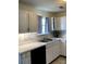 Kitchen with white cabinets, stainless sink, updated fixtures, and black appliances at 2473 Greenwood Rd, Rock Hill, SC 29730