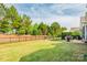 A view of the spacious backyard with a well-maintained lawn and patio furniture at 3001 Henshaw Rd, Waxhaw, NC 28173