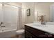 Bright bathroom features a shower-tub combo and a single sink vanity with a large mirror at 3001 Henshaw Rd, Waxhaw, NC 28173