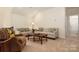 Cozy living room with matching couches, chair, and a hall leading to a bathroom at 3001 Henshaw Rd, Waxhaw, NC 28173