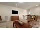 Upstairs Gathering room with television, chess table and seating, with a hall leading to the stairs at 3001 Henshaw Rd, Waxhaw, NC 28173