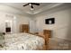 Relaxing bedroom with a ceiling fan, tv, and private bathroom, with carpet flooring and neutral colors at 3001 Henshaw Rd, Waxhaw, NC 28173