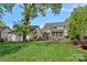 Beautiful backyard featuring a fire pit, inground pool, and lush landscaping at 309 Catawba Ave, Davidson, NC 28036