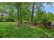 Backyard featuring mature trees, a hammock, and play equipment for outdoor fun at 309 Catawba Ave, Davidson, NC 28036