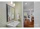 Charming powder room with decorative wallpaper, a pedestal sink, and a mirror with great views at 309 Catawba Ave, Davidson, NC 28036