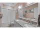 Bathroom featuring double vanity, framed mirror, and a bathtub with a shower at 309 Catawba Ave, Davidson, NC 28036