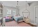 Cozy bedroom with a chandelier, daybed, plush seating, and charming decor at 309 Catawba Ave, Davidson, NC 28036