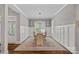 Formal dining room featuring wainscoting, hardwood floors, a modern chandelier, and a large window at 309 Catawba Ave, Davidson, NC 28036