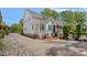 Spacious home with a screened porch, well-maintained lawn, and stone accents at 309 Catawba Ave, Davidson, NC 28036