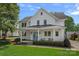 Charming two-story home with a blue front door, porch swing, and manicured lawn at 309 Catawba Ave, Davidson, NC 28036
