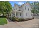 Charming white farmhouse exterior with a inviting front porch and manicured landscaping at 309 Catawba Ave, Davidson, NC 28036