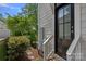 Exterior view of home with landscaping and a black front door, creating an inviting entry at 309 Catawba Ave, Davidson, NC 28036