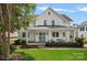 Charming two-story home with a welcoming front porch, swing, and beautifully manicured lawn at 309 Catawba Ave, Davidson, NC 28036