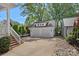 Detached two-car garage with white siding and ample parking space at 309 Catawba Ave, Davidson, NC 28036