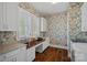 Functional office with built-in desk, natural light, and floral wallpaper at 309 Catawba Ave, Davidson, NC 28036