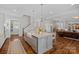 Open-concept kitchen with granite counters, stainless appliances, and hardwood floors flowing into the living area at 309 Catawba Ave, Davidson, NC 28036